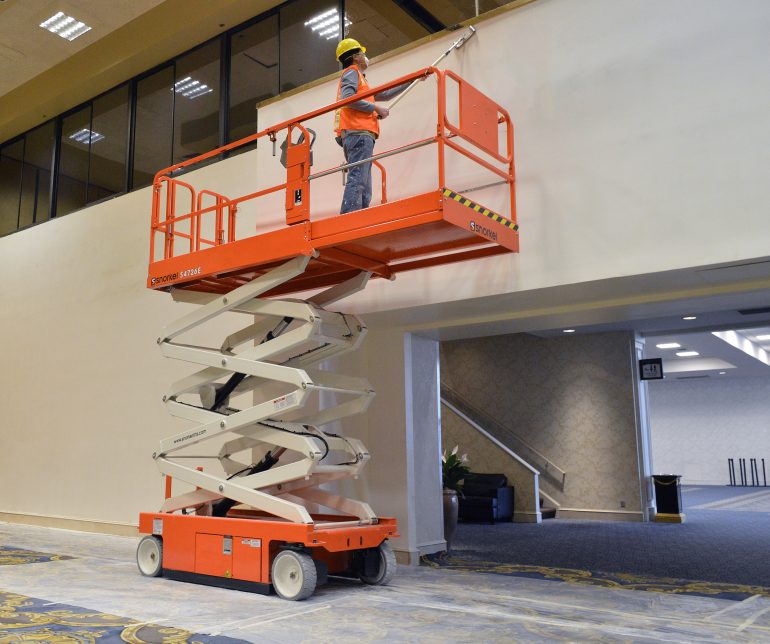 A scissor lift being used for painting/decorating.