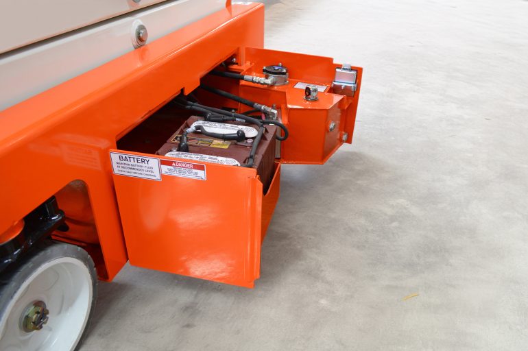 The battery compartment of an electric scissor lift.