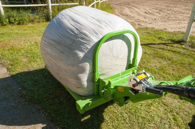 A bale handling attachment for a mini loader.