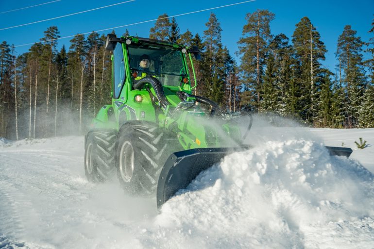 Snow plough compact loader attachment.